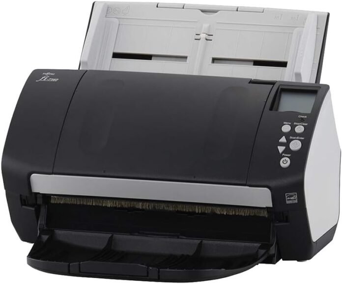 Fujitsu FI-7160 document scanner placed on an office desk, scanning multiple sheets efficiently.