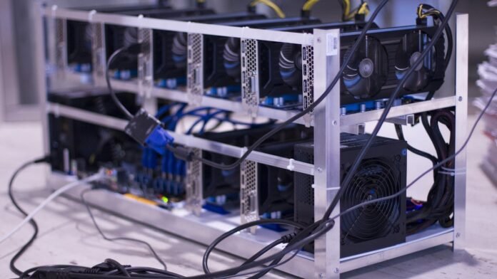 A Bitcoin mining machine setup with ASIC miners, power supply, and cooling system, used for validating Bitcoin transactions.