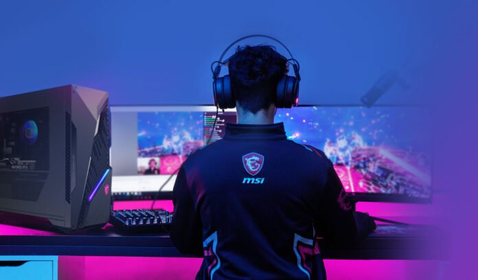 A gamer using a high-performance PC setup with a mechanical keyboard, gaming mouse, and dual monitors for an immersive gaming experience.