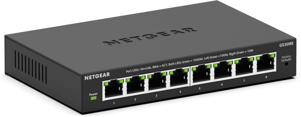 An affordable 5-port gigabit switch on a wooden desk with minimal cables.