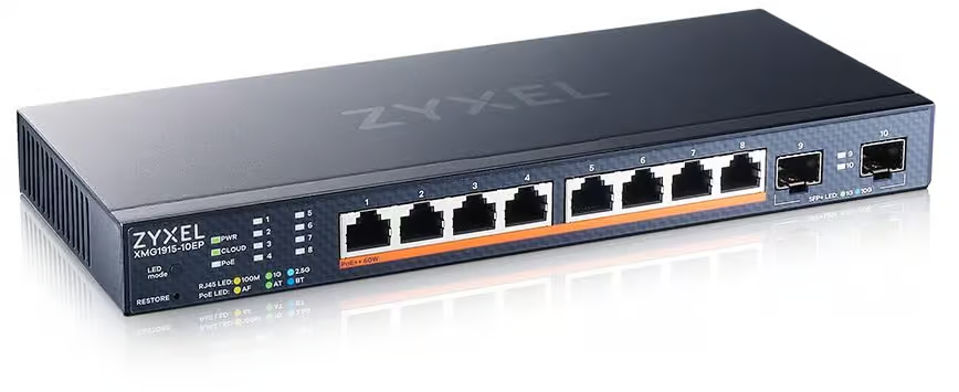A small 8-port unmanaged network switch placed on a desk with connected Ethernet cables.